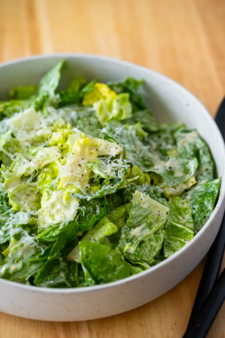 Close Up of Lettuce dressed with Caesar Salad Dressing