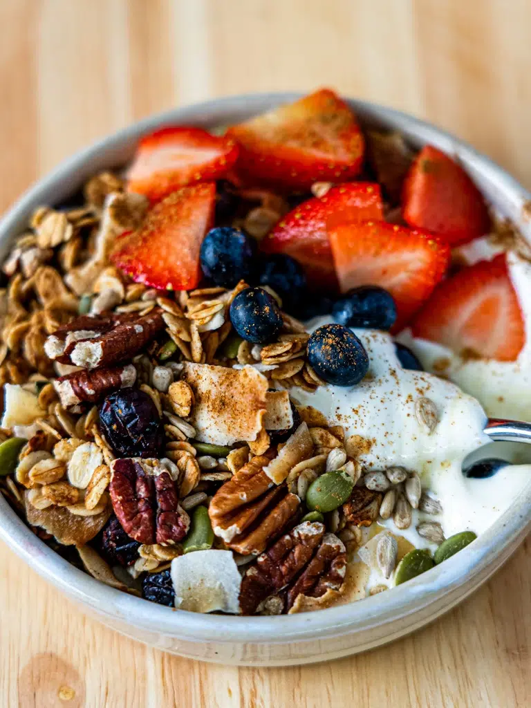 Close-up of Crunchy homemade granola with a spoon in a bowl