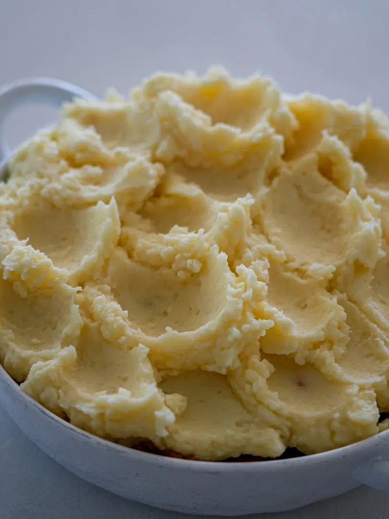Uncooked mashed potato layer for a comforting Shepherd's Pie.