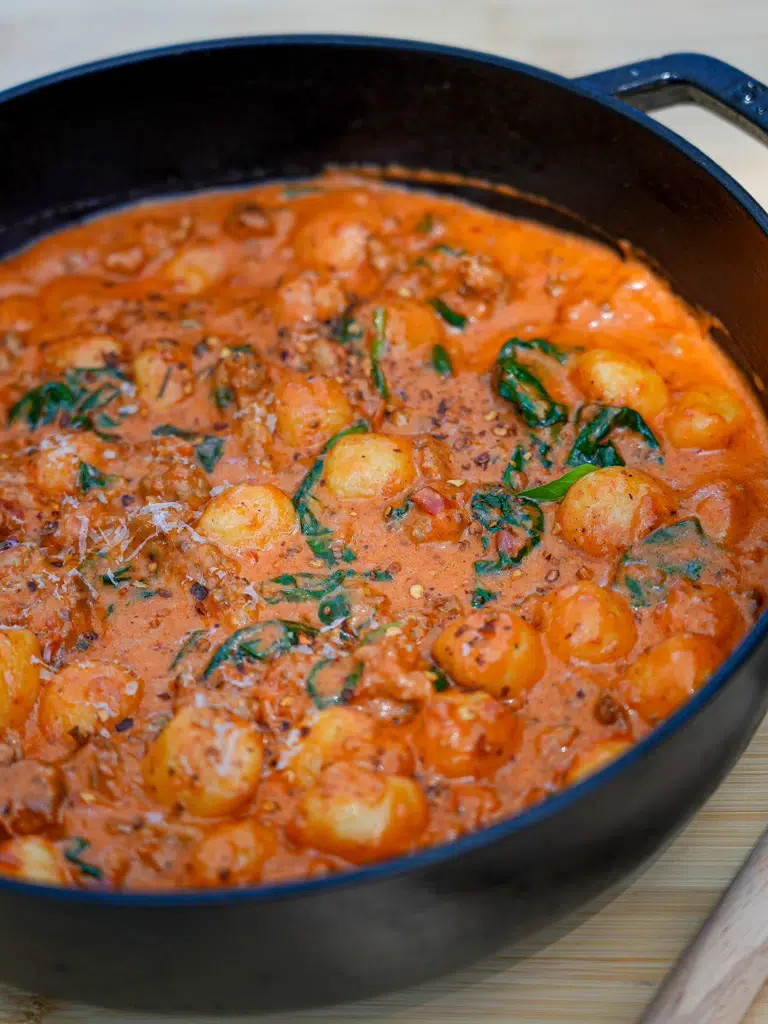 Delicious creamy sausage gnocchi dish in a pan, ready to serve