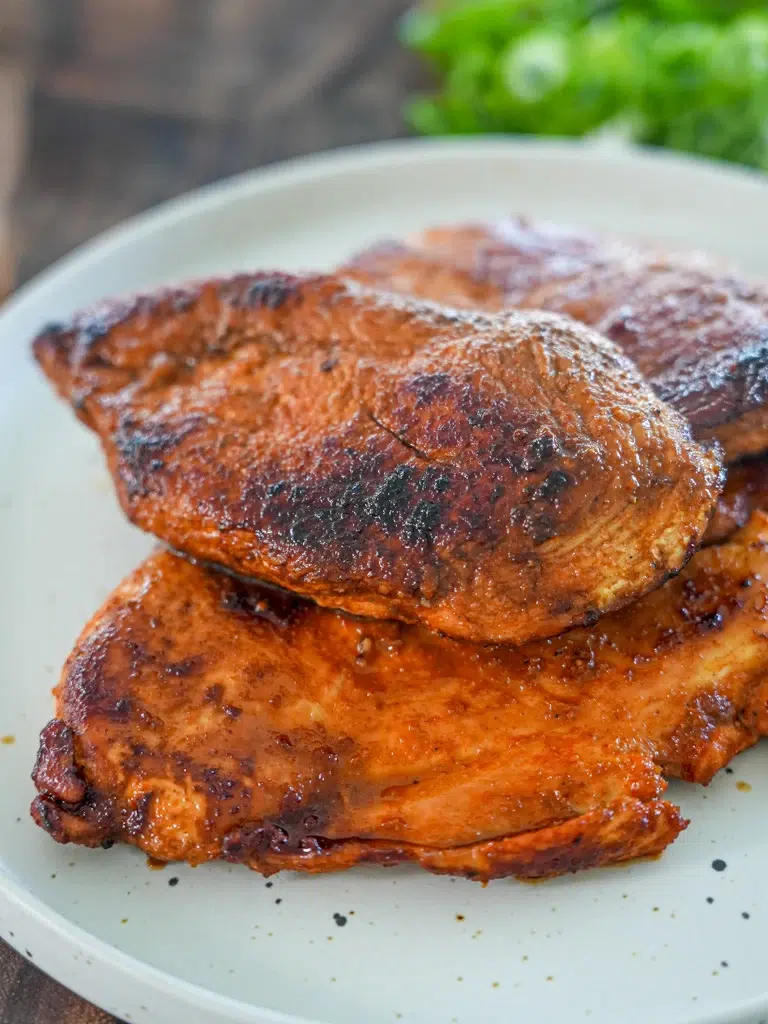 Cooked chicken breasts served on a plate, tender and juicy.