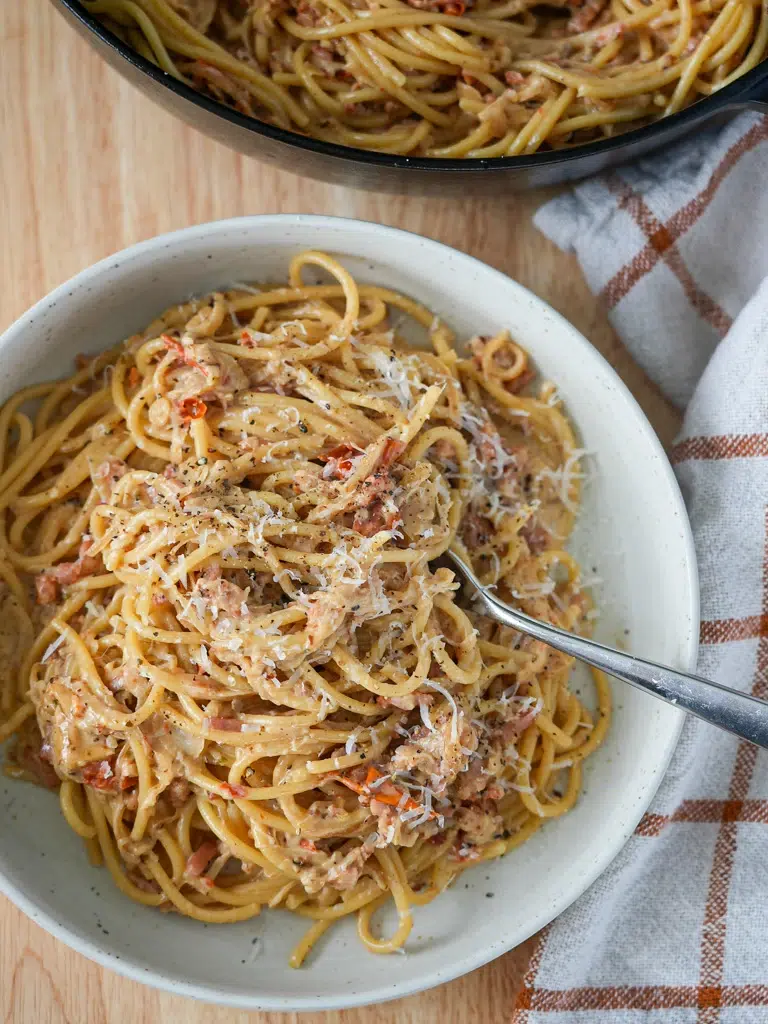 Overhead shot of a bowl of caramelized onion pasta with a fork resting on the pasta.