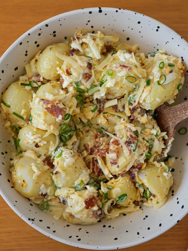 Ultimate loaded potato salad in a white bowl
