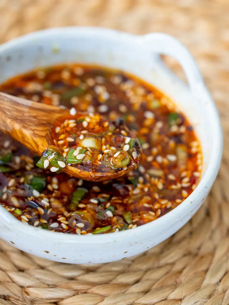 Glossy Dumpling Dipping Sauce on a spoon, shown from the side.