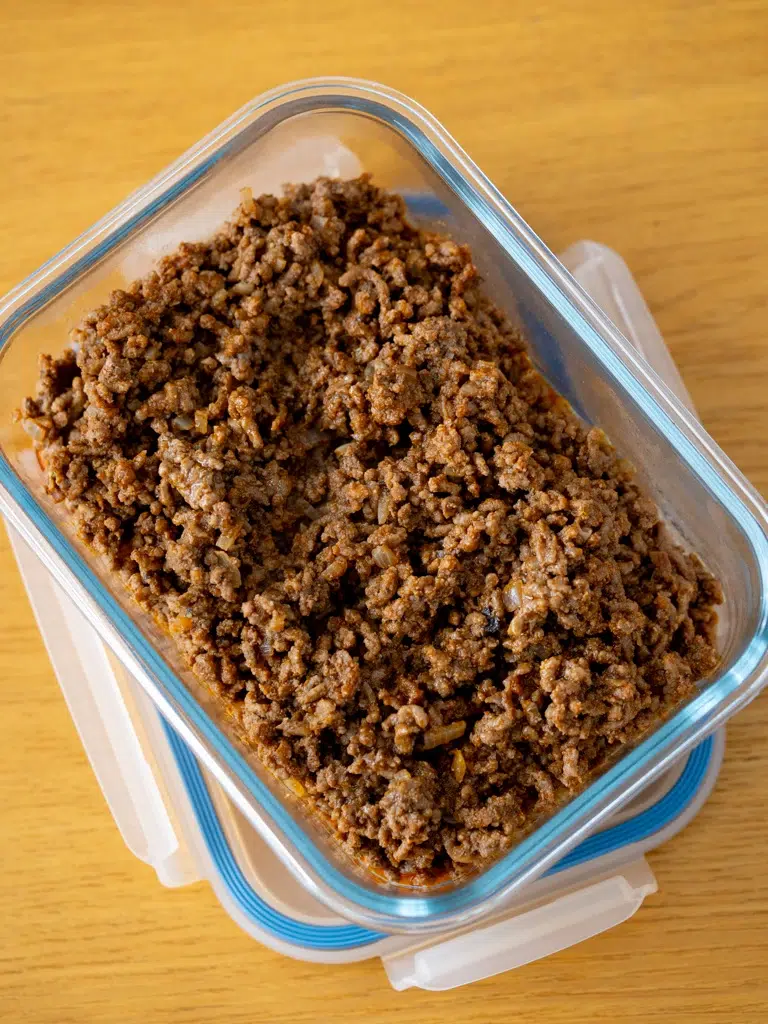 Seasoned cooked beef in a container.
