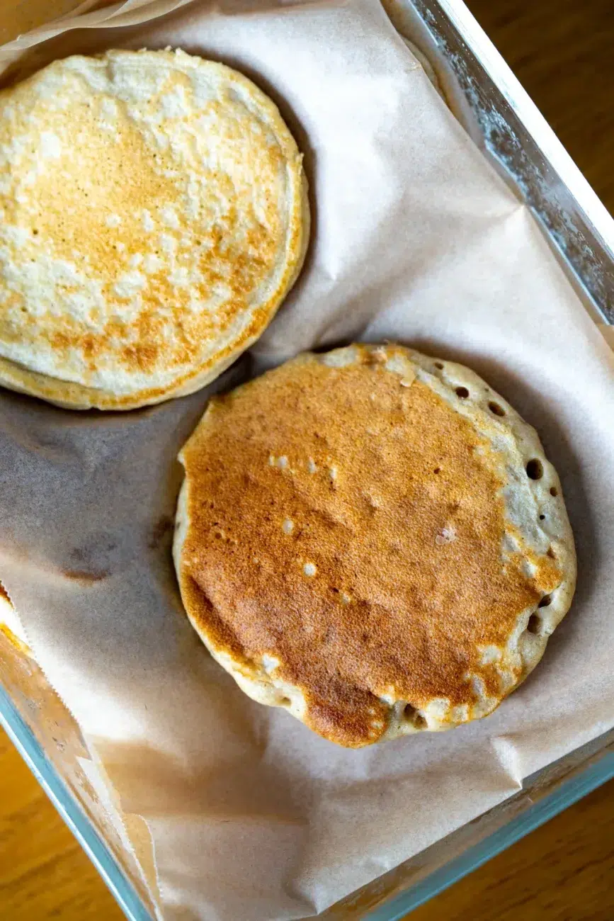 Pancakes in a container with baking paper between layers to stop sticking
