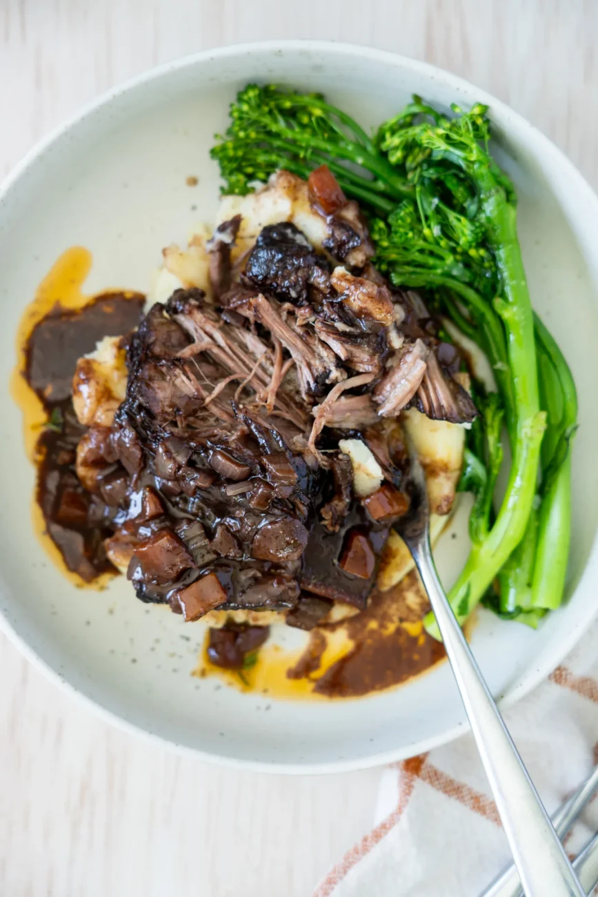 Red Wine Braised Beef Short Ribs shredded with fork on plate