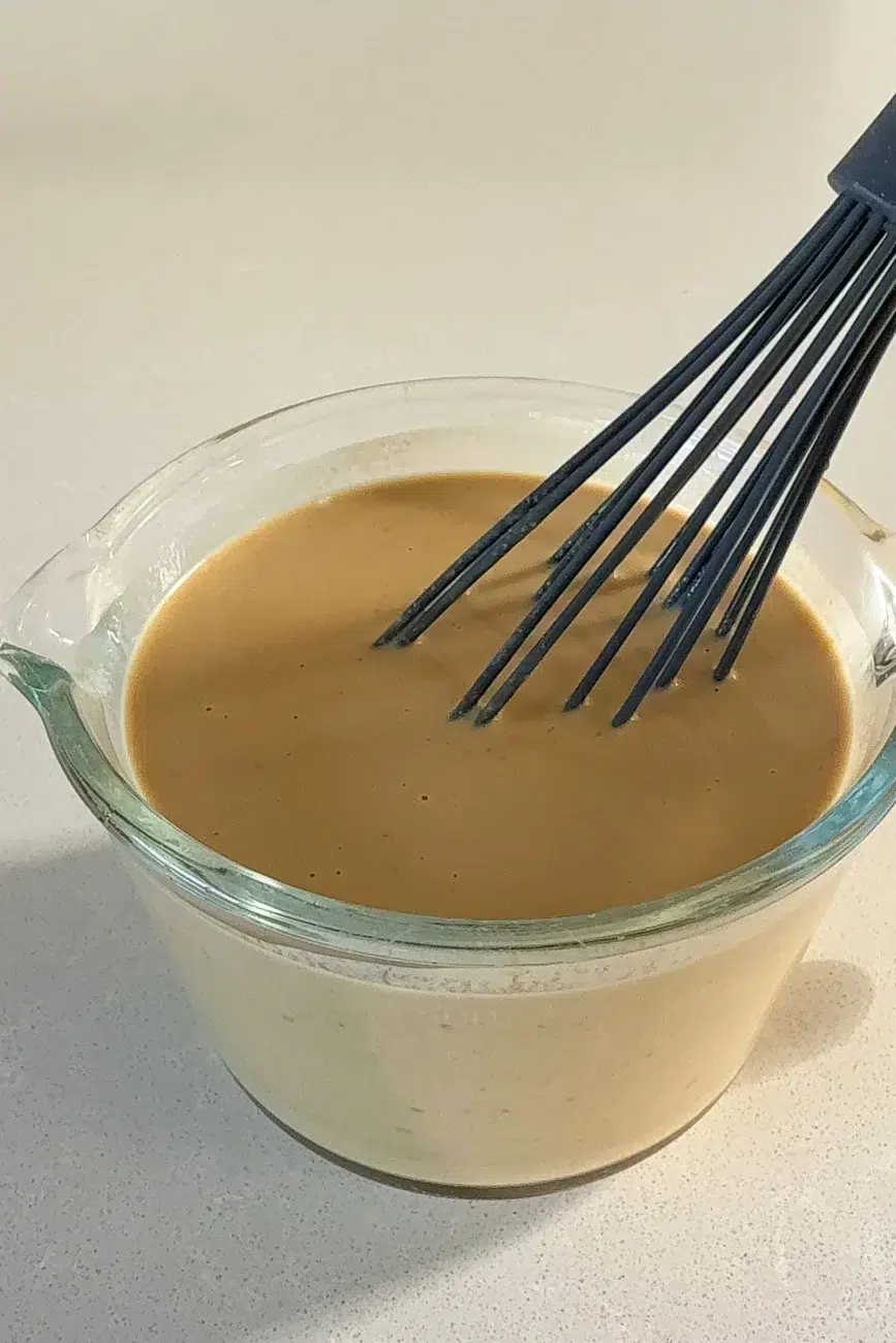 Satay sauce ingredients mixed in jug