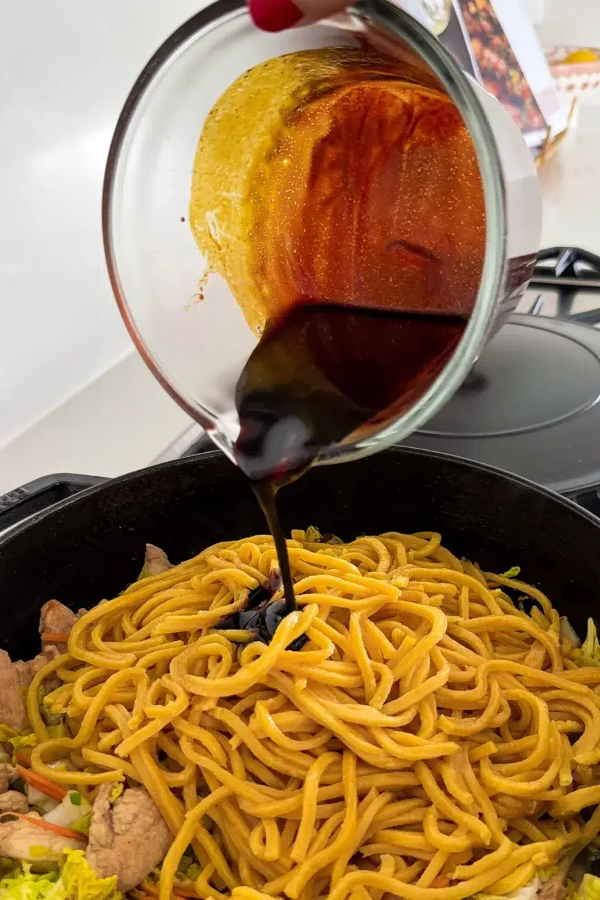 Noodles added with sauce drizzled on top