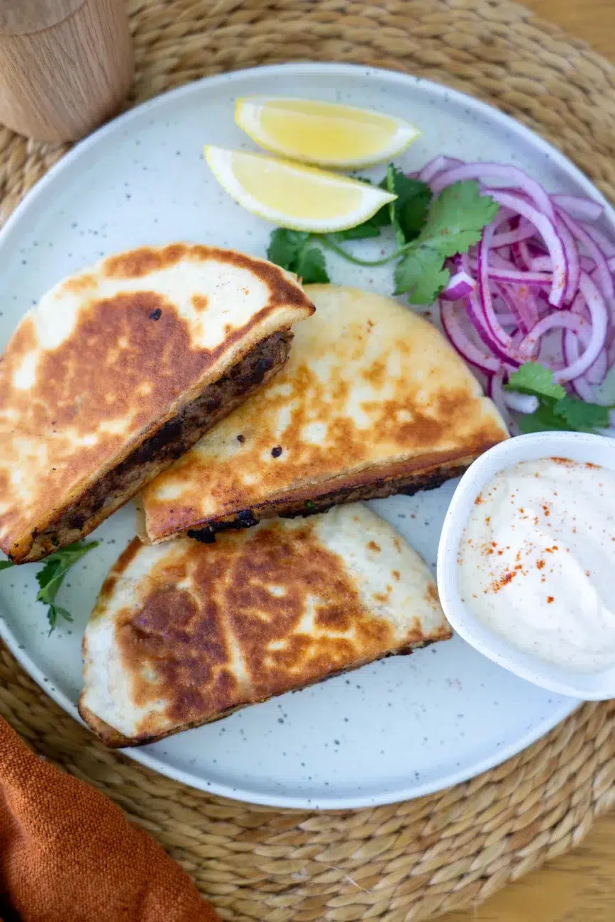 plated stuffed pita arayes with pickled onion coriander and dip