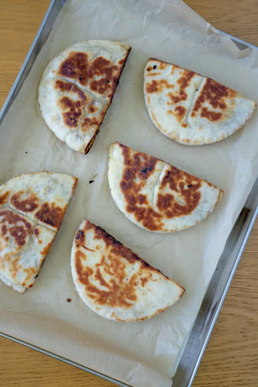 stuffed pita on baking tray being kept warm in the oven