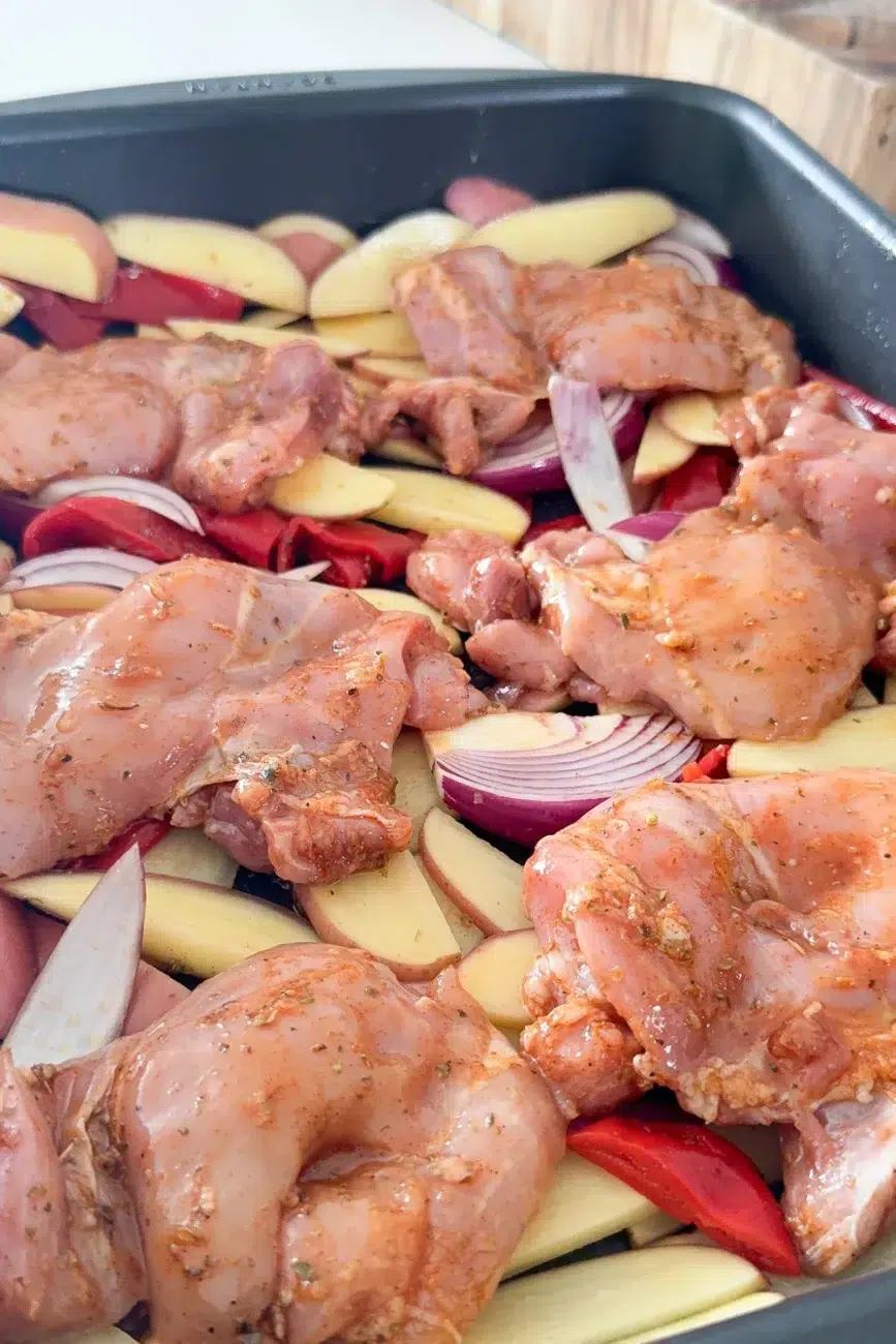 Chicken marinated and placed on top of potatoes