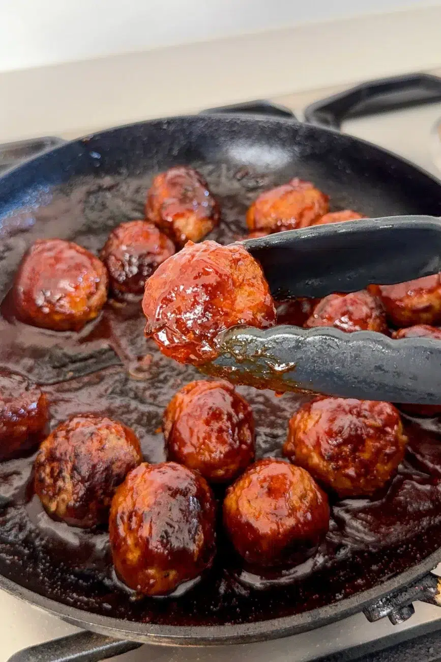 Finished meatball glazed in sticky BBQ sauce