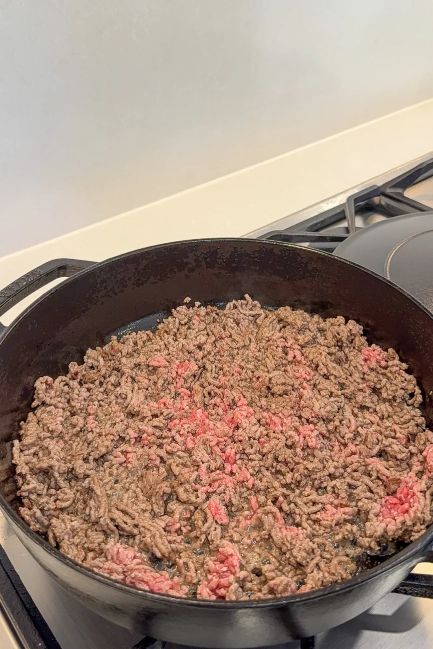 Browning minced (ground) beef in a cast-iron pan for Korean-style noodles