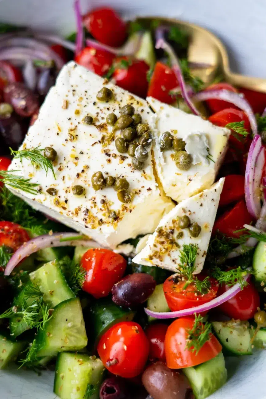 Feta broken into pieces with capers and pepper