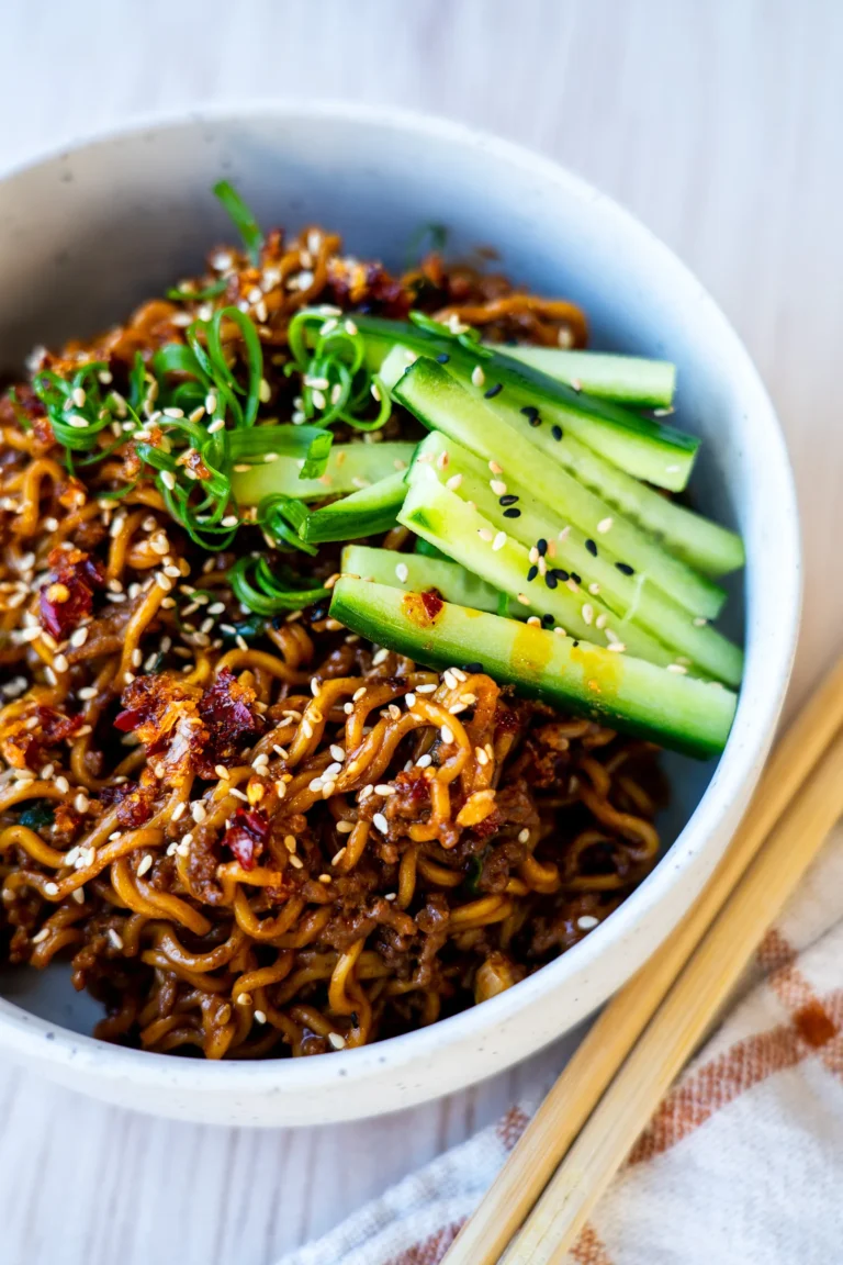One-pan Korean-style beef noodles topped with sesame seeds, cucumber and spring onion