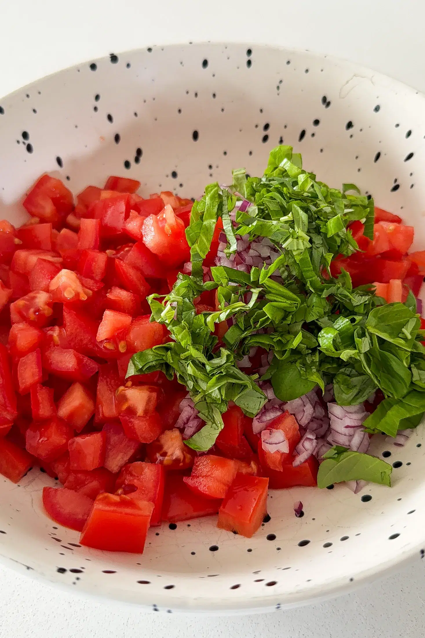 Fresh tomatoes being prepared for bruschetta salad
