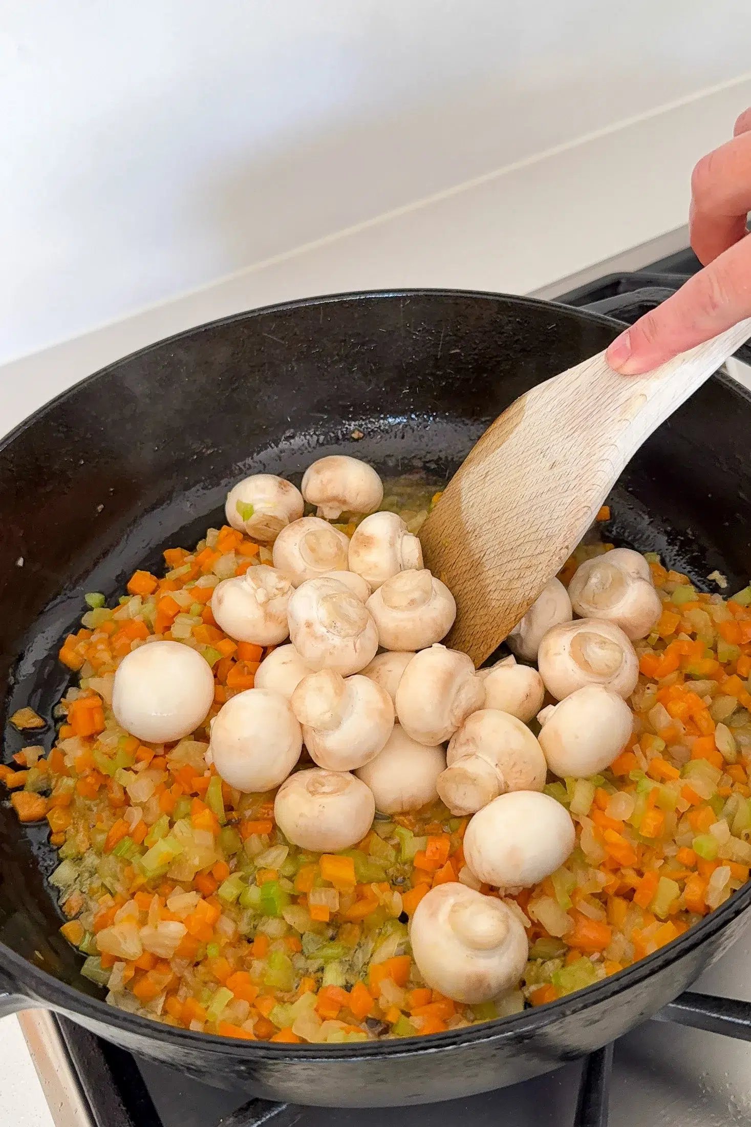 Whole button mushrooms added to the soffritto for chicken cacciatore