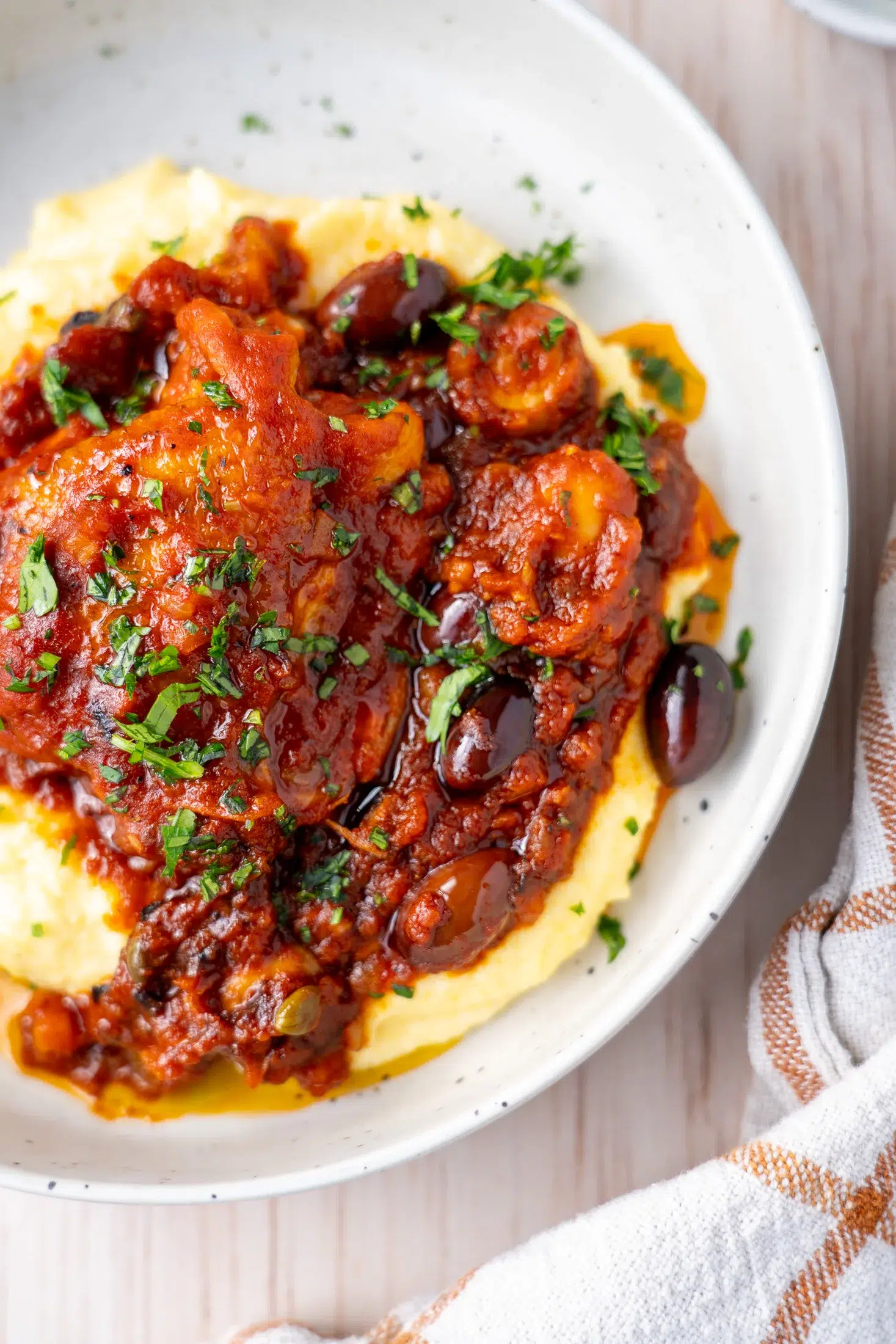 Rich tomato sauce, tender chicken and creamy parmesan polenta served in a bowl