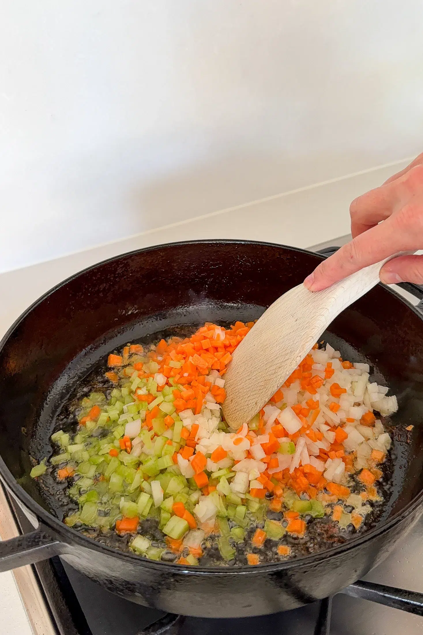 Soffritto of onion carrot and celery cooking in a skillet for cacciatore