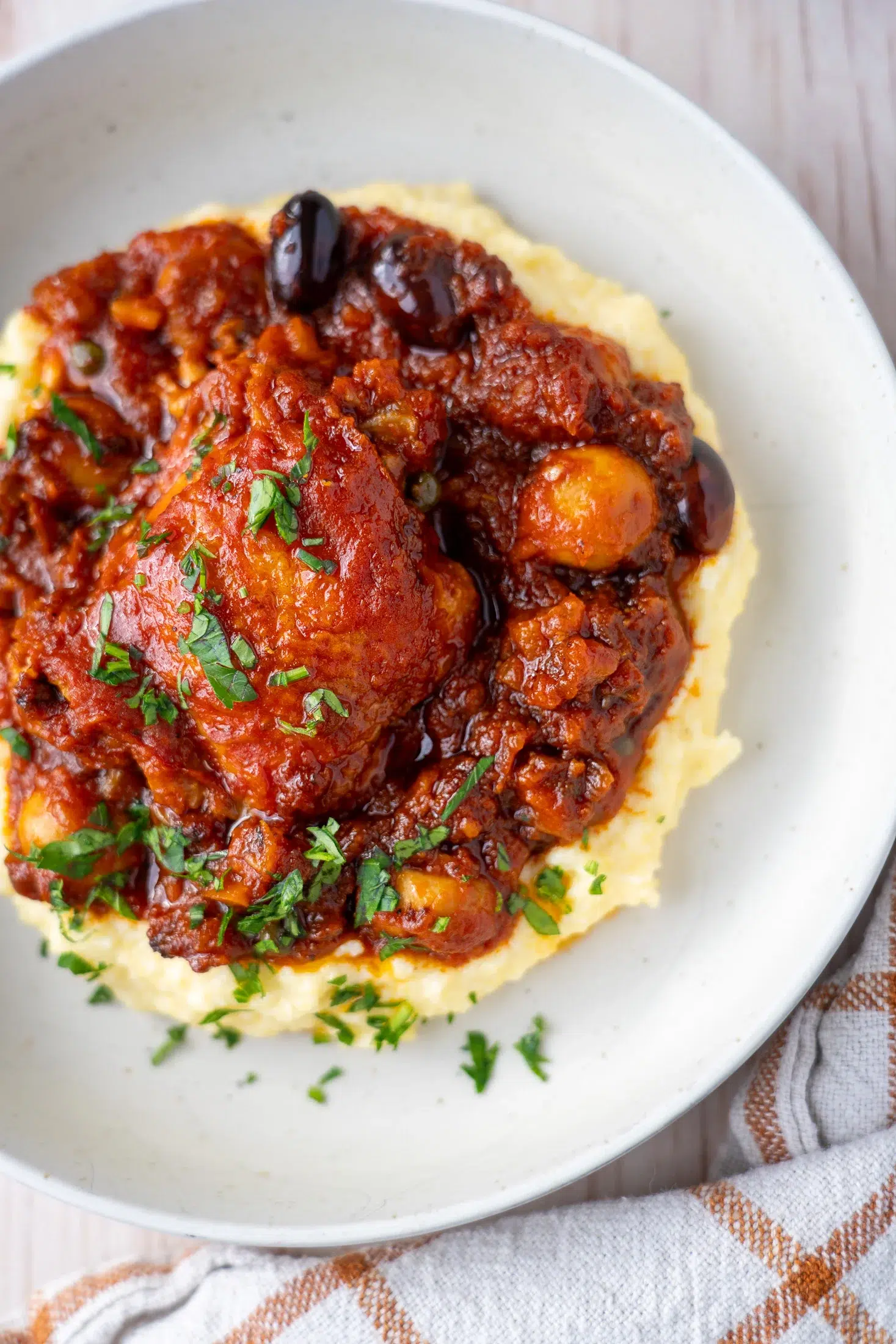 Fall-apart tender chicken thigh with olives in rich tomato sauce