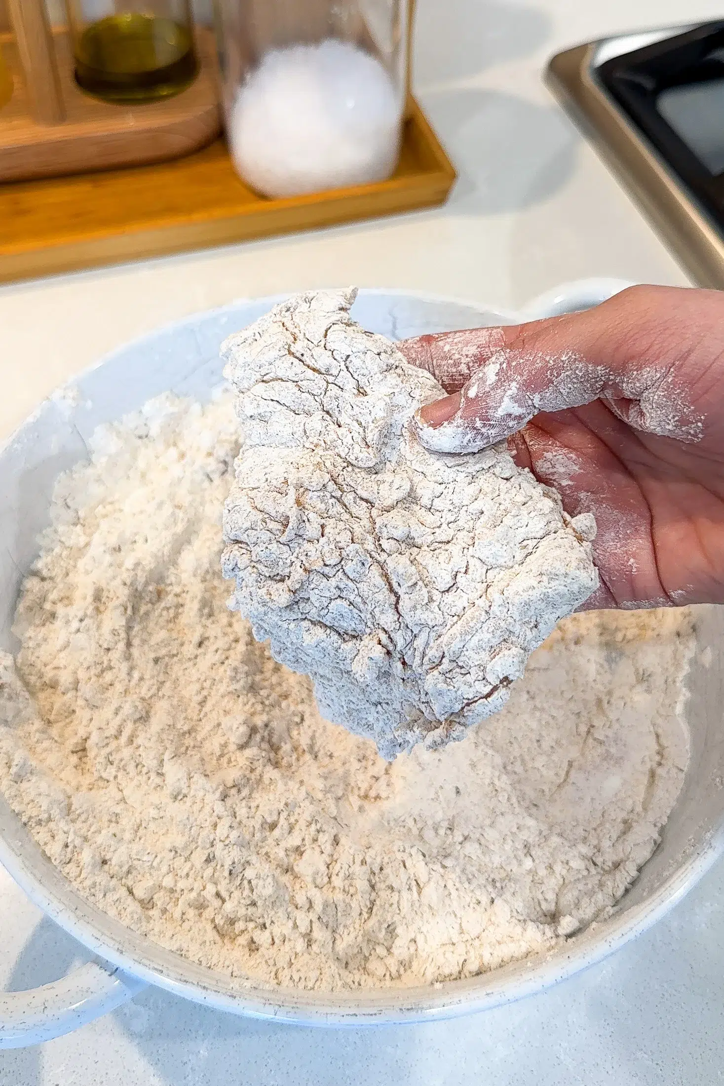 Chicken piece with craggy seasoned flour coating ready for frying