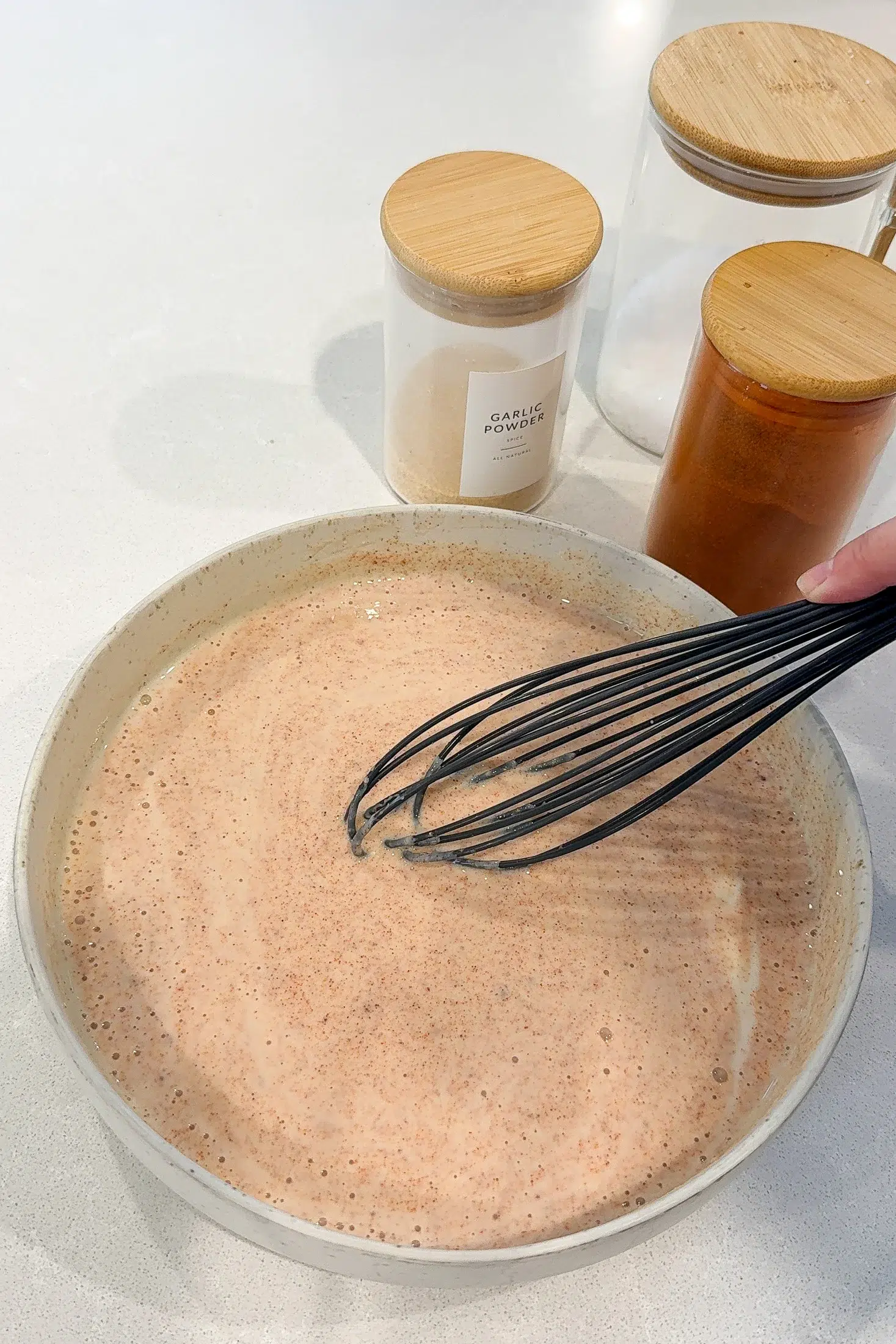 Seasoned buttermilk coating for fried chicken in a large bowl