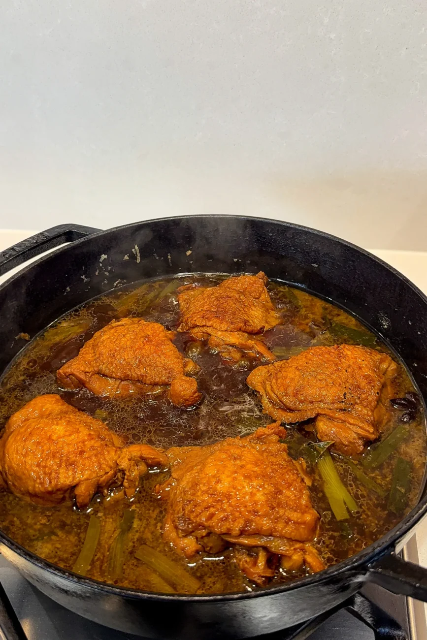 Chicken simmering in reduced glossy soy sauce