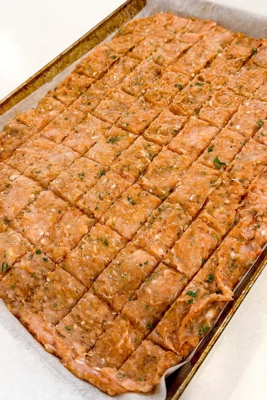 Kebab mixture on baking paper and scored ready for oven