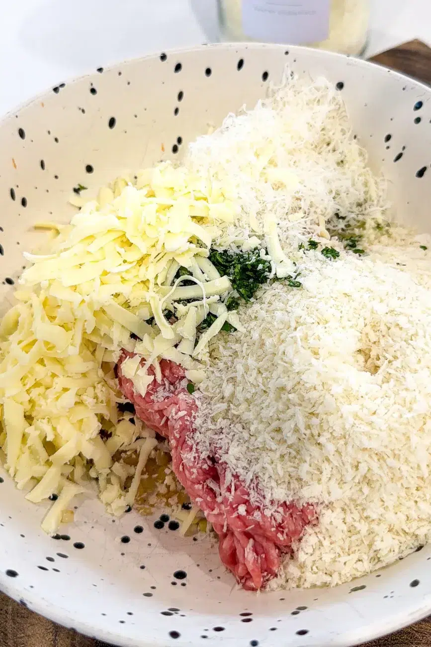 Meatball ingredients added to bowl ready to be mixed