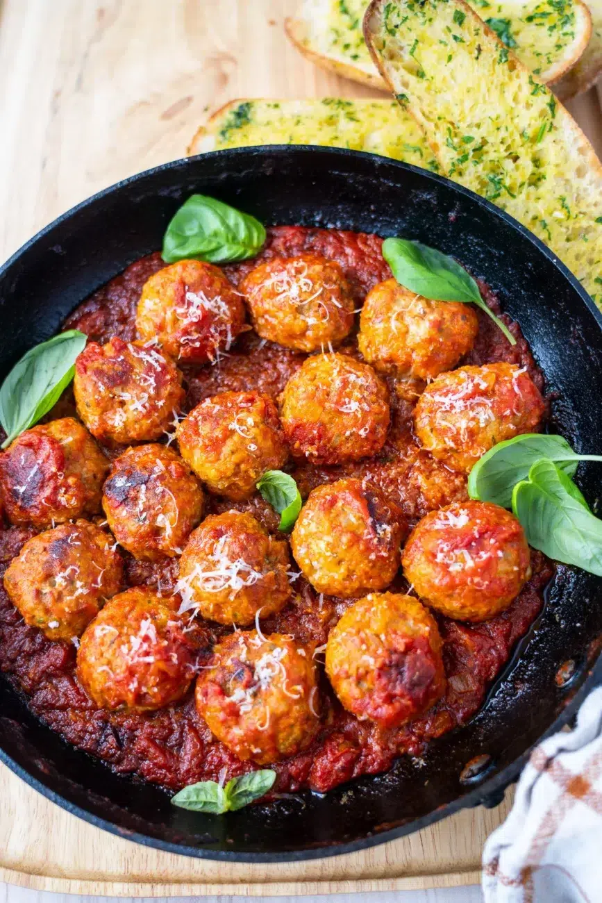 Meatballs in pan with side of garlic bread