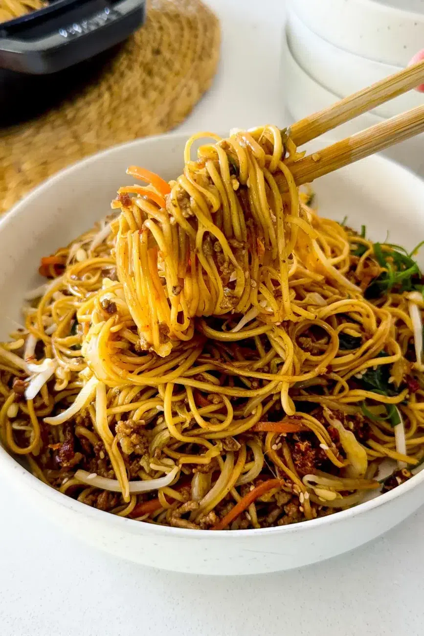 Noodles in bowl with chopsticks digging in