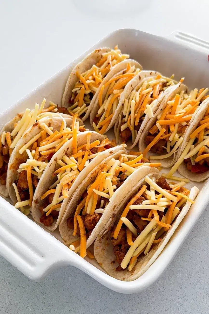 Tacos filled with cheese ready for the oven